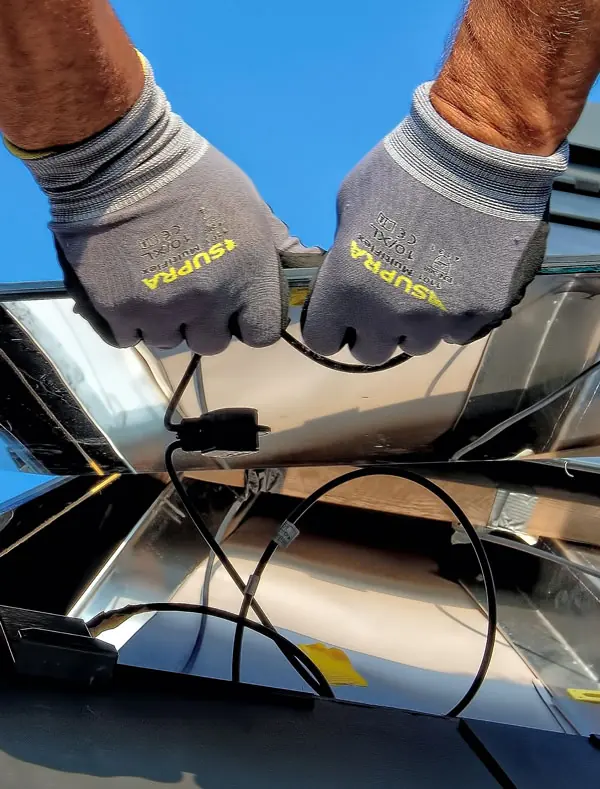 An installer connecting the cables on a solar panel